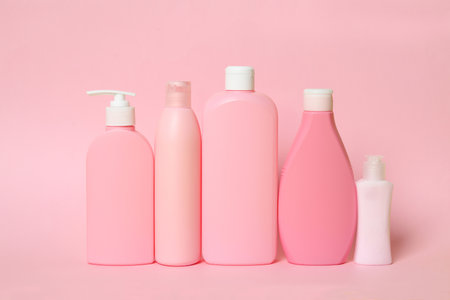 Different bottles of shampoo on pink background. natural cosmetic productsの写真素材