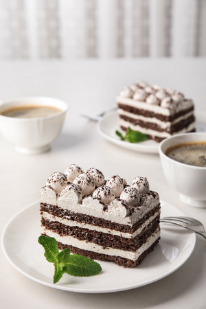 Composition with tiramisu cakes and mint on tableの写真素材