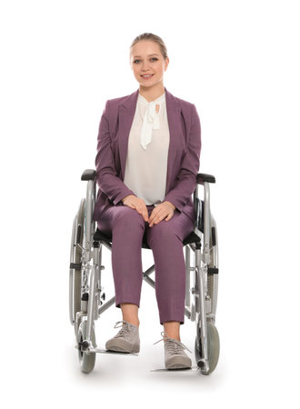 Beautiful young businesswoman in wheelchair isolated on whiteの写真素材