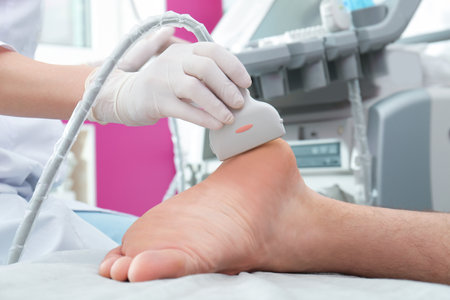 Doctor conducting ultrasound examination of patient's foot in clinic, closeupの写真素材