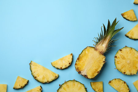 Flat lay composition with cut and fresh juicy pineapples on color background, space for textの写真素材