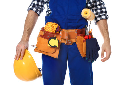 Construction worker with tool belt on white background, closeupの写真素材