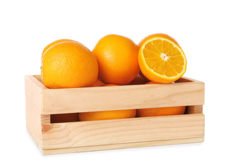 Wooden crate full of fresh oranges on white backgroundの写真素材