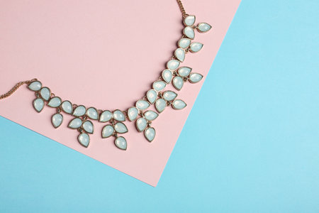 Elegant necklace on color background, top view with space for text. luxury jewelryの写真素材