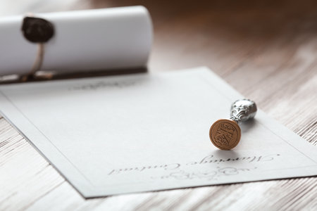 Vintage notary stamp and document on wooden table, closeup. Space for textの写真素材