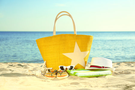 Composition with stylish beach accessories on sand near the seaの写真素材