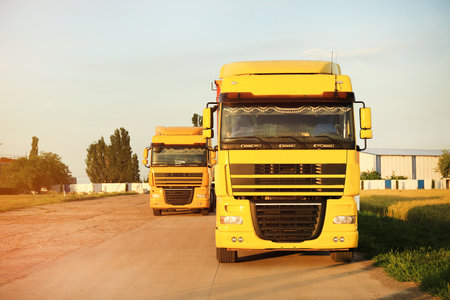Modern yellow trucks parked on country roadの写真素材