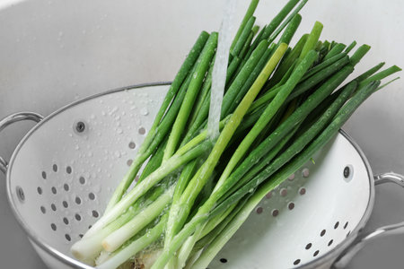 Washing fresh green onions in kitchen sink