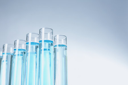 Test tubes with liquid on light background, closeup with space for textの写真素材