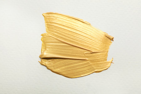 golden paint brush strokes on white backgroundの写真素材