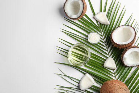 Jar of natural organic oil and coconuts on white background, top viewの写真素材