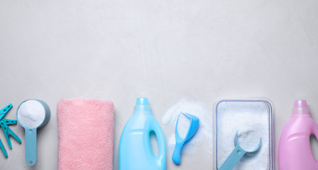 Flat lay composition with laundry detergent on light background, space for textの写真素材