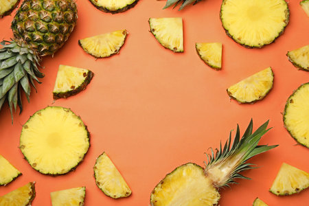 Flat lay composition with cut and fresh juicy pineapples on color background, space for textの写真素材