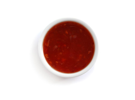 Delicious tomato sauce in bowl on white background, top viewの写真素材