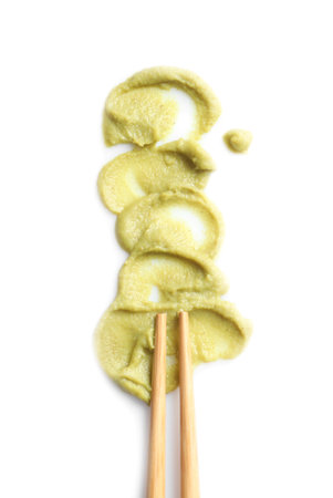 Delicious spicy wasabi and chopsticks on white background, top view. traditional sauceの写真素材