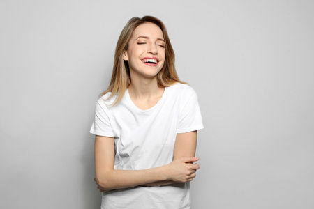 Portrait of young woman with beautiful face on gray backgroundの写真素材