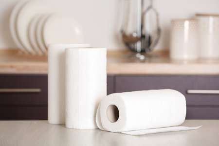 Rolls of paper towels on table in kitchenの写真素材