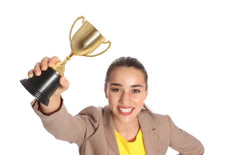Portrait of happy young businesswoman with gold trophy cup on white backgroundの写真素材