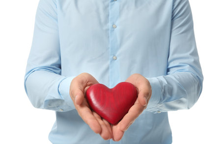 Young man holding red heart on white background, closeup. Donation conceptの写真素材
