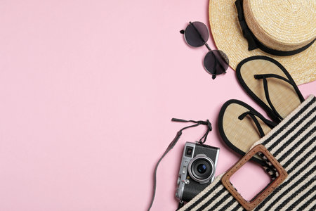 Flat lay composition with stylish beach accessories on pink background, space for textの写真素材