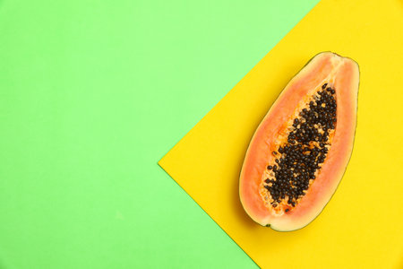 Fresh juicy halved papaya on color background, top view. Space for textの写真素材