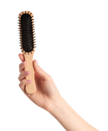 Woman holding wooden hair brush against white background, closeupの写真素材