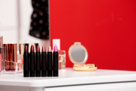 Different lipsticks on dressing table. Space for textの写真素材