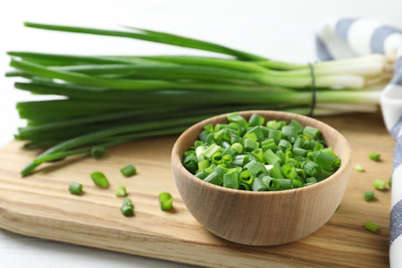 Wooden bowl with cut green onion board. Space for textの写真素材