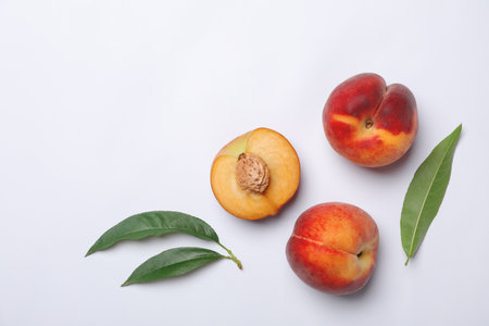 Flat lay composition with sweet juicy peaches on light background. Space for textの写真素材