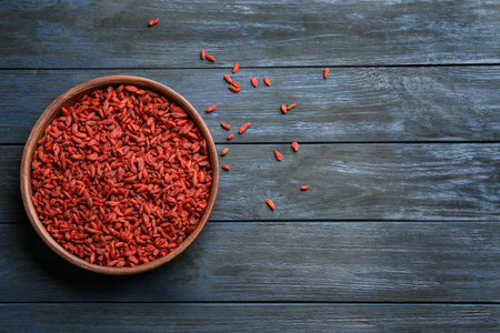 Bowl of dried goji berries on wooden table, top view with space for text. healthy superfoodの写真素材