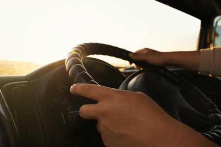 Man driving modern truck on sunny day, closeup