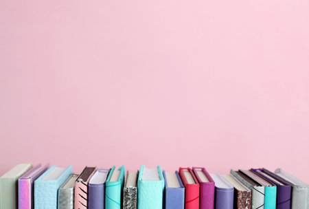 Composition with books on pink background. Space for textの写真素材