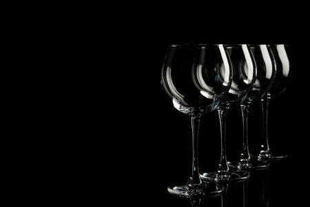 Set of empty wine glasses on black background. Space for textの写真素材