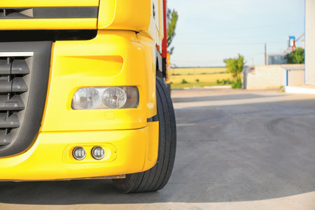 Modern yellow truck on road, closeup. Space for textの写真素材