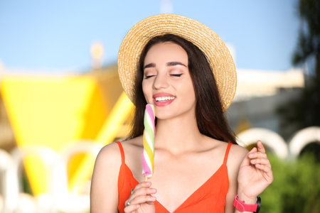 Happy young woman with delicious ice cream outdoorsの写真素材
