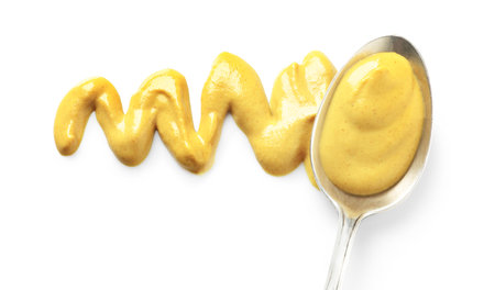 Delicious mustard and spoon on white background, top view. spicy sauceの写真素材