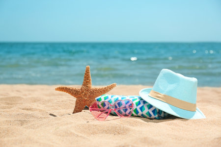 Set of different beach objects on sand near sea. Space for textの写真素材