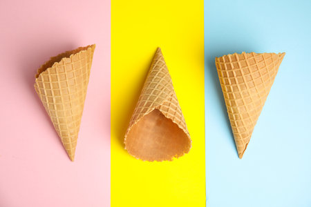 Empty wafer ice cream cones on color background, flat layの写真素材