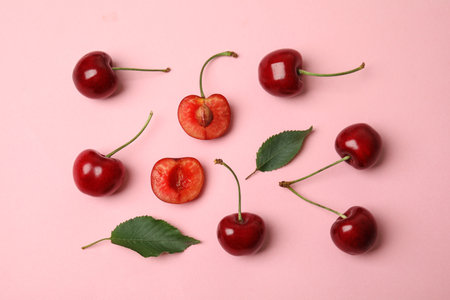 Flat lay composition with ripe sweet cherries on pink backgroundの写真素材
