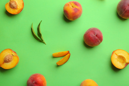 Flat lay composition with fresh peaches on green backgroundの写真素材