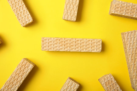 Flat lay composition with delicious crispy wafers on yellow backgroundの写真素材