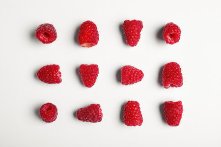 Composition with delicious ripe raspberries on white background, top viewの写真素材