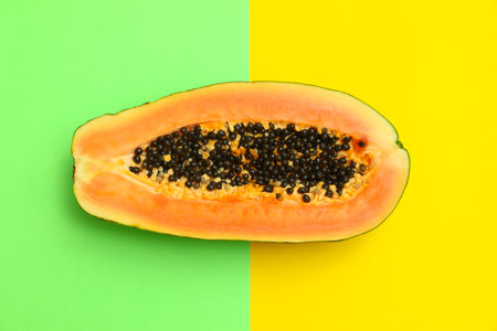 Fresh juicy halved papaya on color background, top viewの写真素材