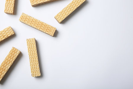 Flat lay composition with delicious crispy wafers on white background. Space for textの写真素材