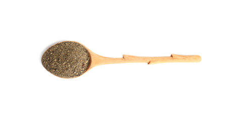 Spoon of ground black pepper isolated on white, top viewの写真素材