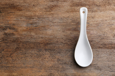 Clean empty miso spoon on wooden background, top view. Space for textの写真素材