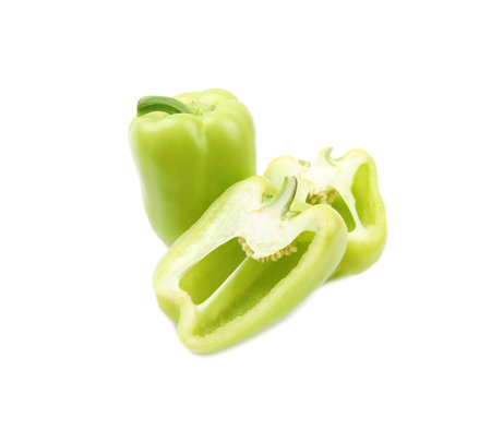 Whole and cut green bell peppers on white backgroundの写真素材