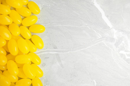 Flat lay composition with jelly beans on light background. Space for textの写真素材