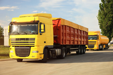 Modern bright trucks parked on country roadの写真素材