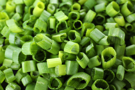 Cut fresh green onions as background, closeup